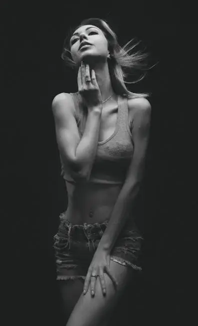 A captivating black and white studio portrait of a woman posing with elegance and confidence.